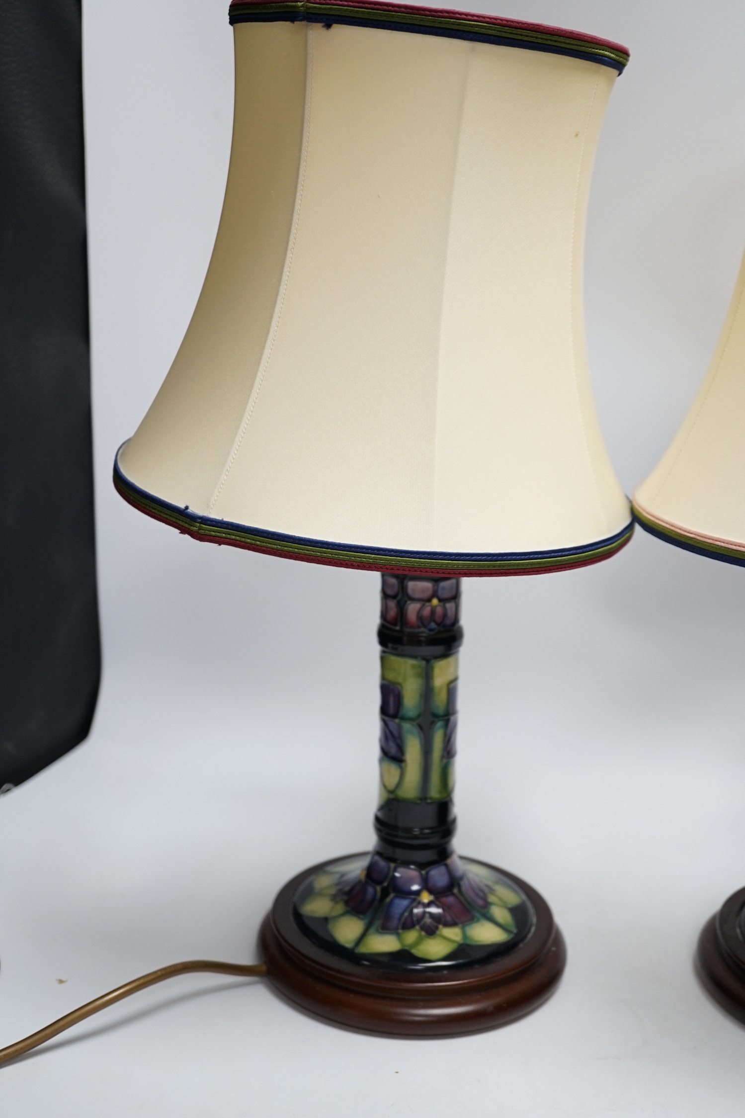 Two Moorcroft lamp bases, in Oberon and Violet patterns, 47cm high